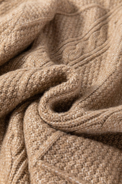 Parchment cable knit fabric texture of sweater dress.