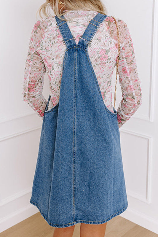 Dusk blue wide strap denim mini dress with button front and pockets.