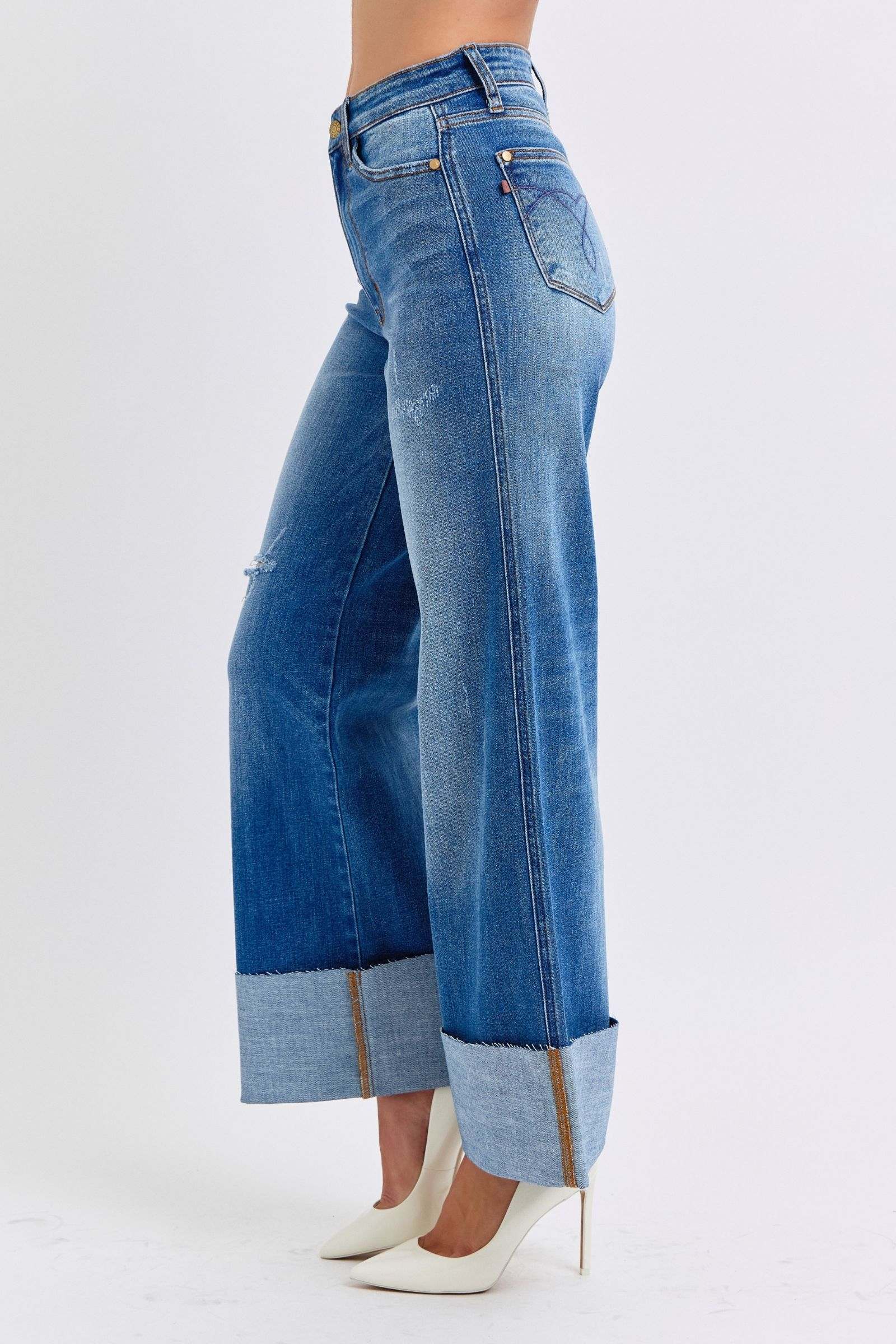 Judy Blue distressed high waist wide leg jeans showcasing stylish worn-in look with cuffed hems.