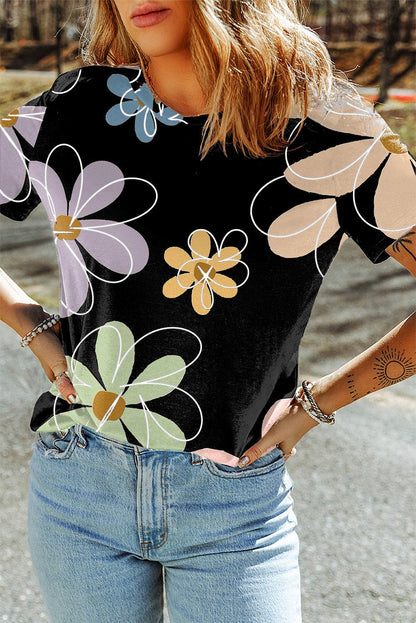Black summer t-shirt with vibrant multicolor flower print and round neck, styled with light blue jeans