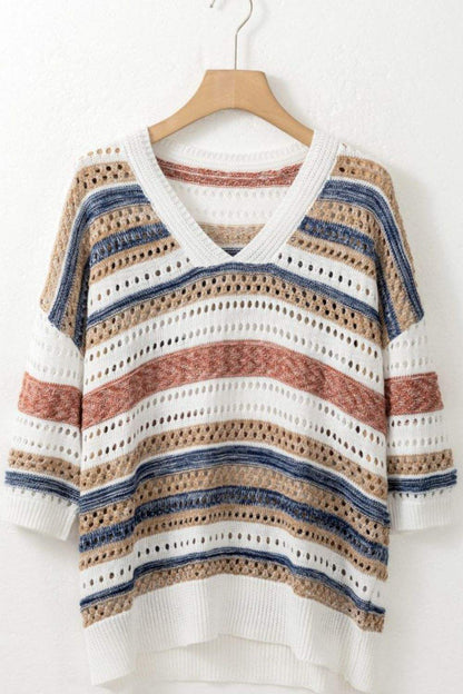 Striped knit top with hollow-out half sleeves on a hanger.