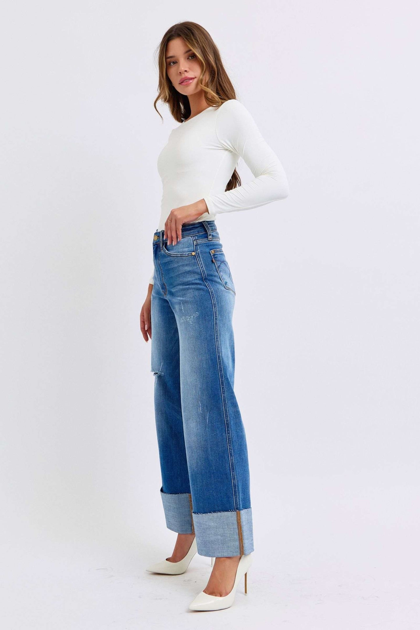 Judy Blue distressed high waist wide leg jeans styled with a white top and heels.