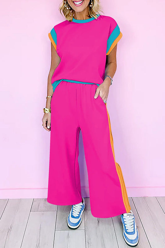 Strawberry pink color block two-piece set with relaxed fit top and wide-leg jogger pants in bright casual style