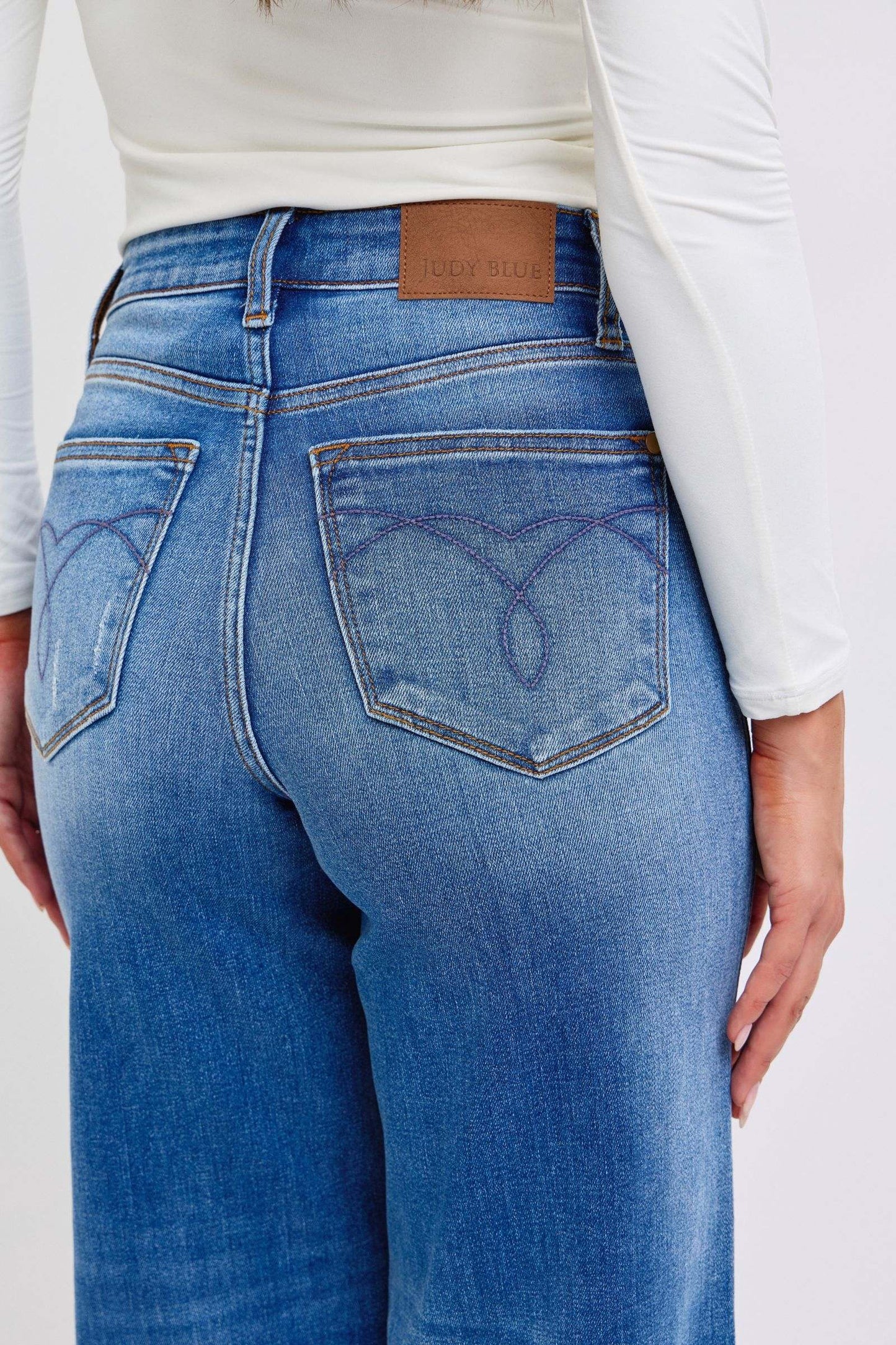 Judy Blue distressed high waist wide leg jeans showcasing back view with pocket detail.