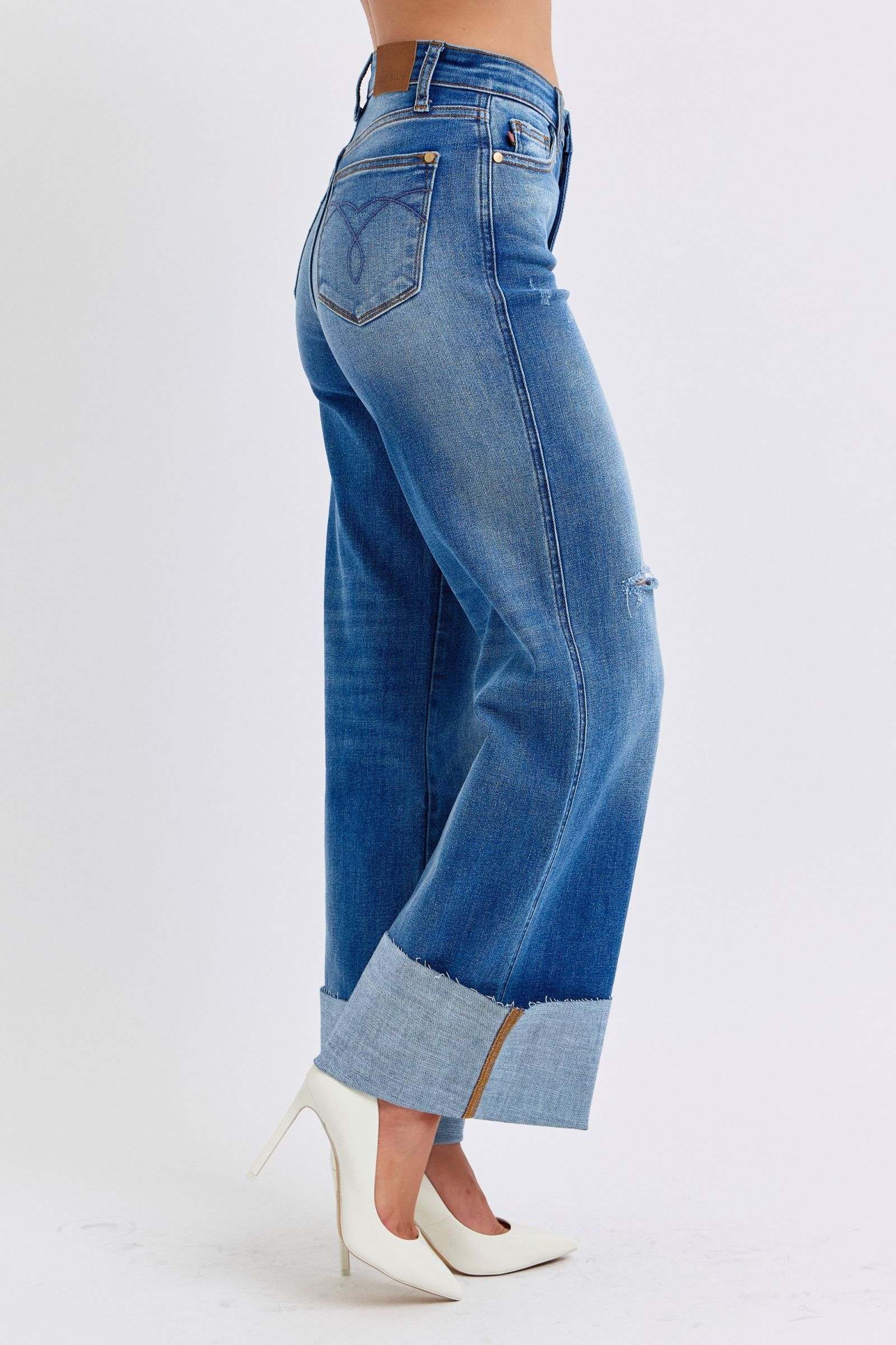 Judy Blue distressed high waist wide leg jeans with rolled cuffs, side view.