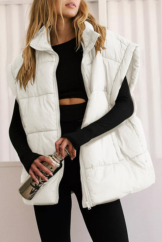 Solid Zipper Stand Neck Oversized Puffer Vest in white worn over black outfit.