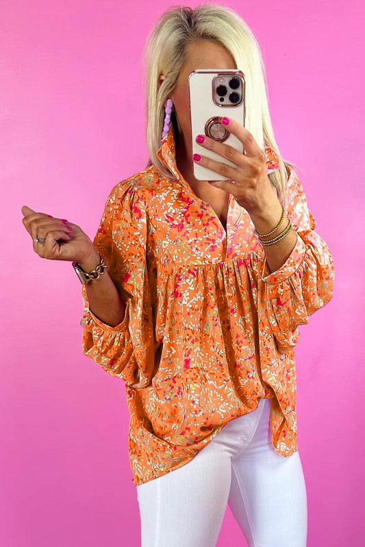 Orange abstract print collared V-neck babydoll blouse worn by a person taking a mirror selfie.
