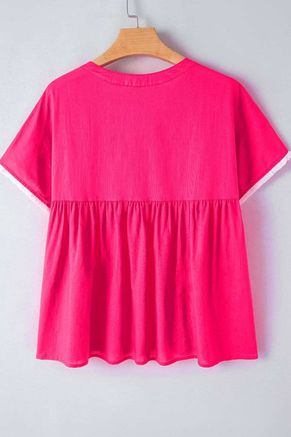Bright pink summer blouse with embroidered tassel tie and geometric neck design, highlighting a flowy, lightweight silhouette.