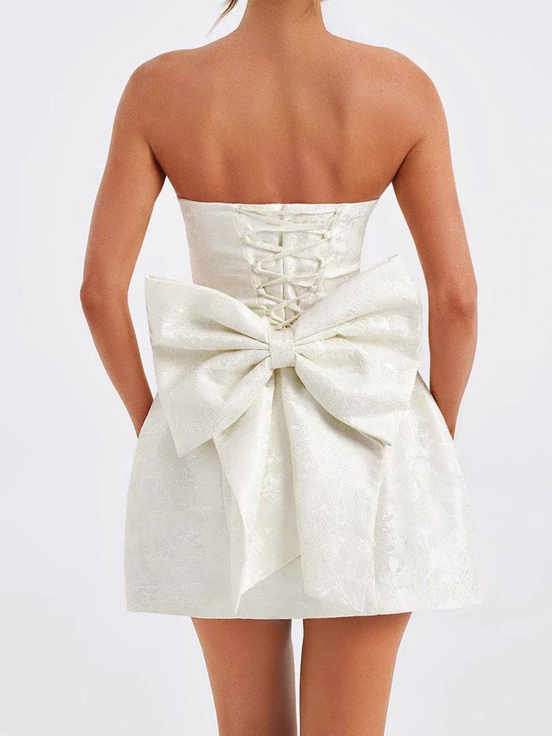 Lace-up sleeveless satin mini dress with bow detailing in white.