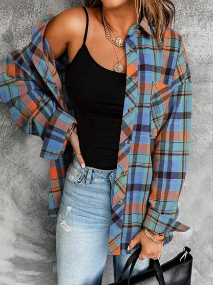 Plaid collared neck long sleeve shirt with pocket detail in blue, orange, and green tones.