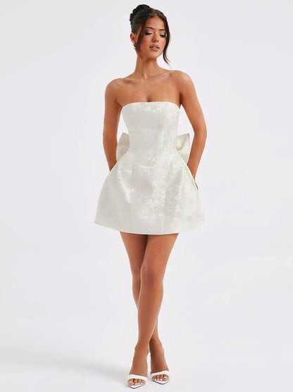 Lace-up sleeveless satin mini dress with bow in off-white.