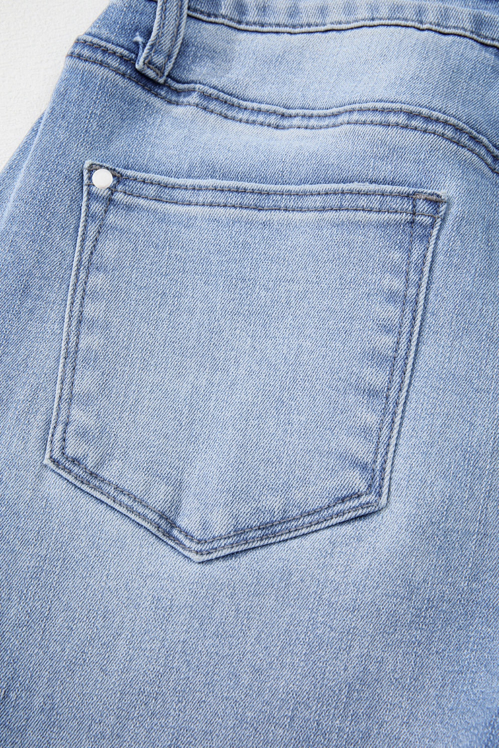 Women's flared jeans with high rise waist and raw edge hem