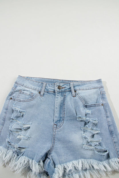 Light blue distressed high waist denim shorts with ripped detailing and raw hem.